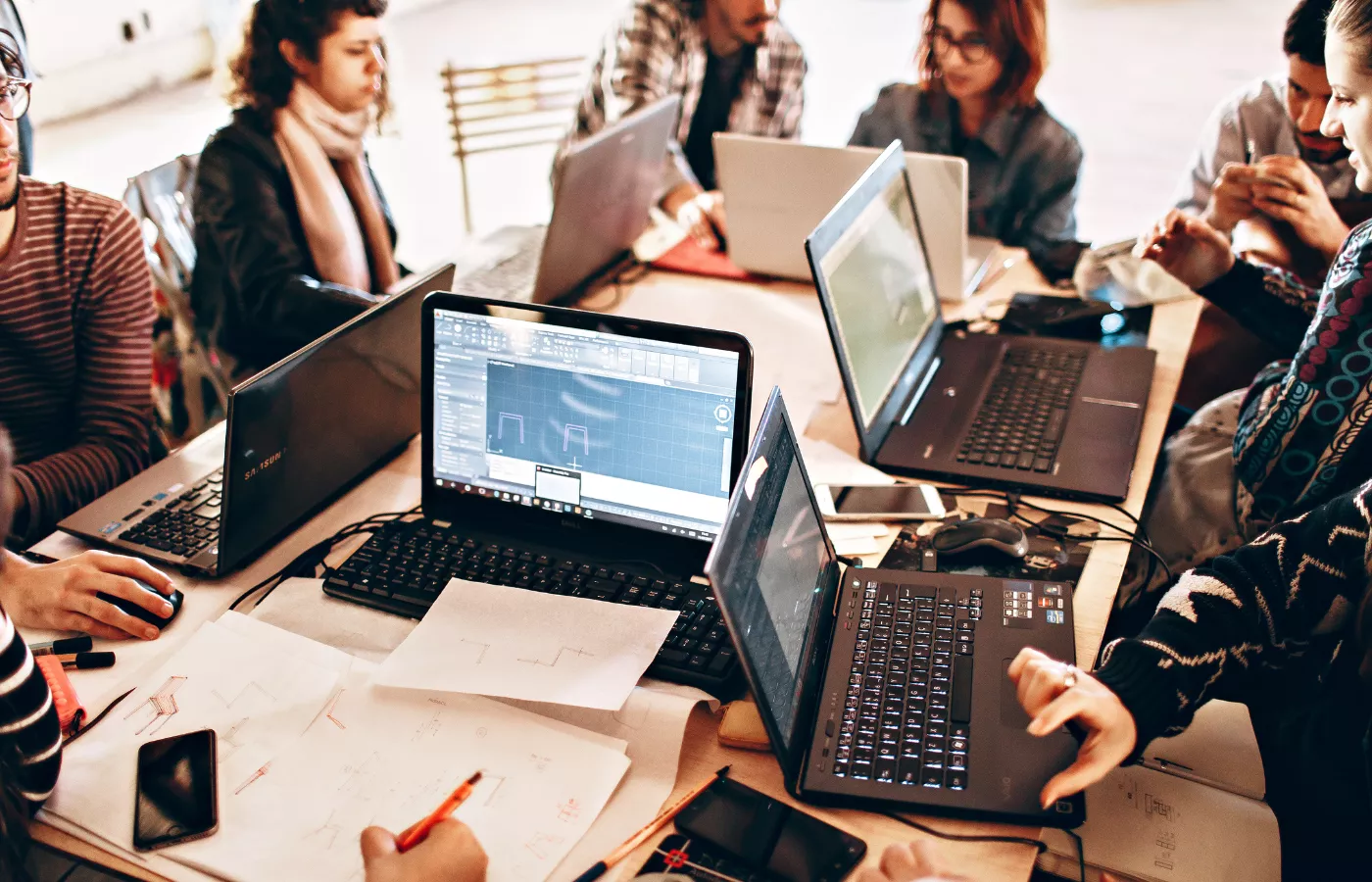 Full service digital growth agency team collaborating on multiple laptops with 15+ years of experience