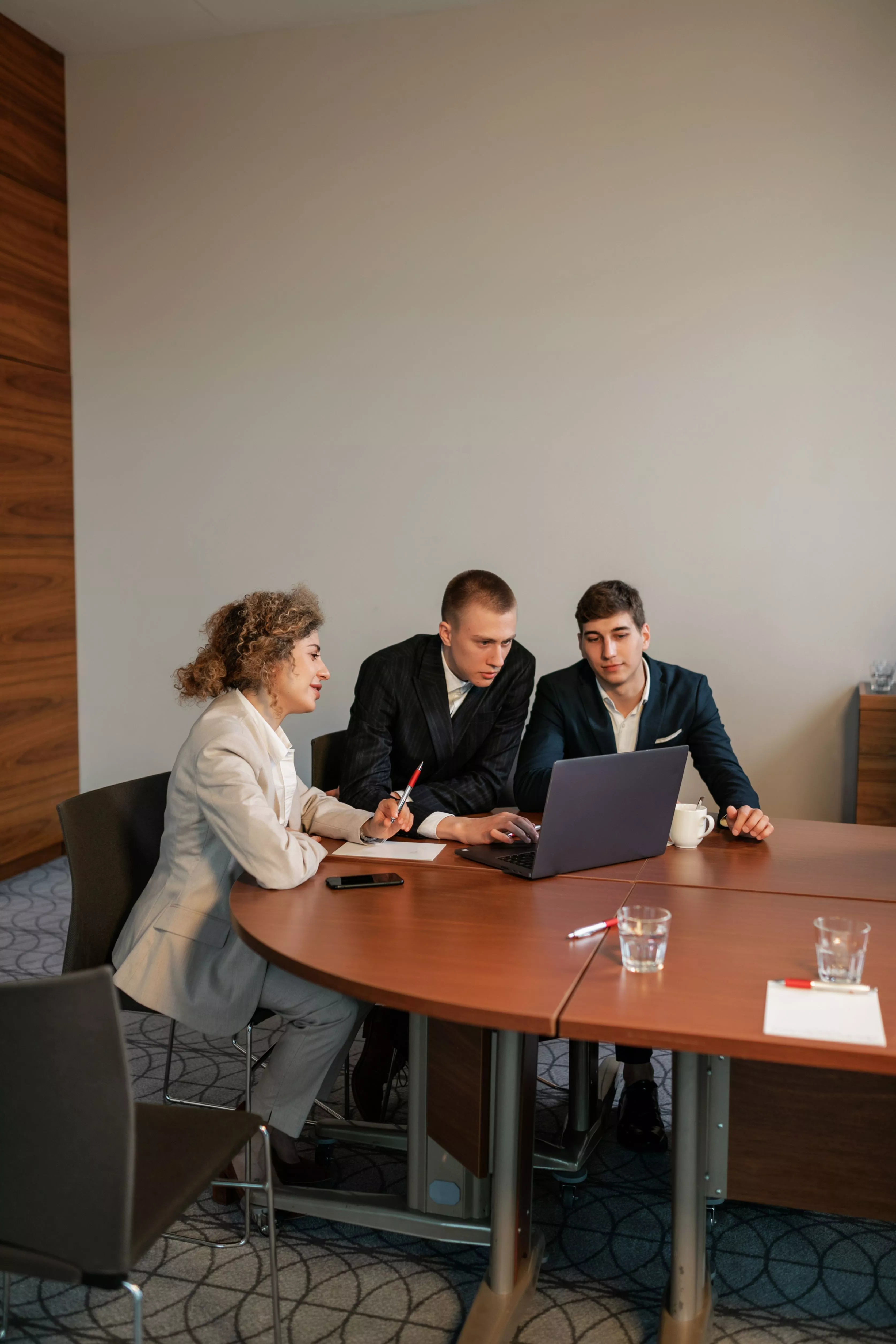 Growth strategy consulting firm team collaborating around a laptop during a client strategy session